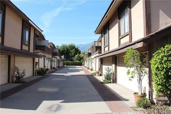 Front view of a row of townhouses with garages.