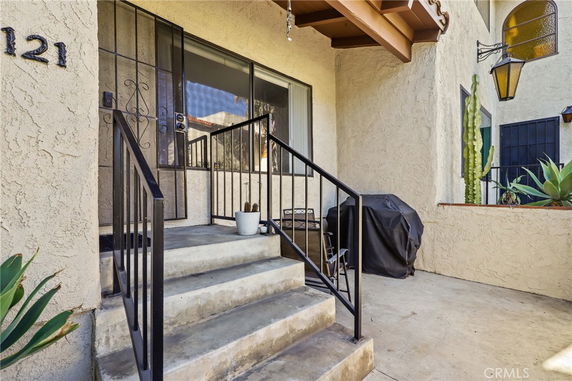 Front view of a house with a small porch area and steps.