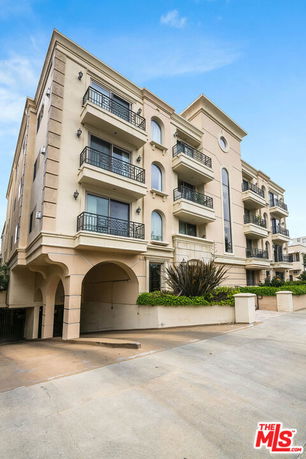 Front view of a multi-story building with balconies.