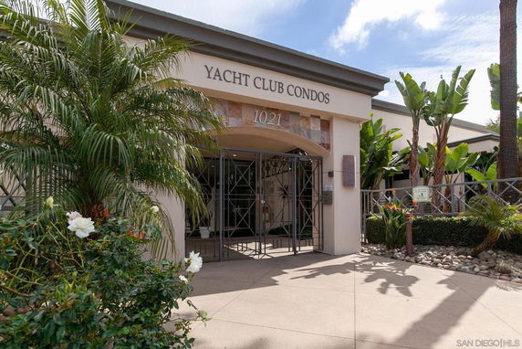 Front view of a condo building with gated entrance.