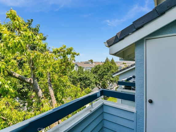 View of surrounding area from a rooftop balcony.