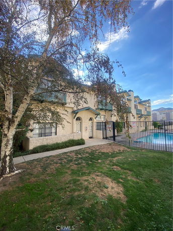 Front view of a multi-story building with balconies.