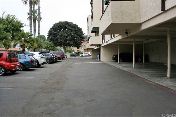 Outdoor parking area adjacent to a multi-level building.