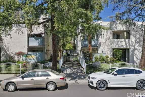 Front view of a multi-story residential building with balconies.