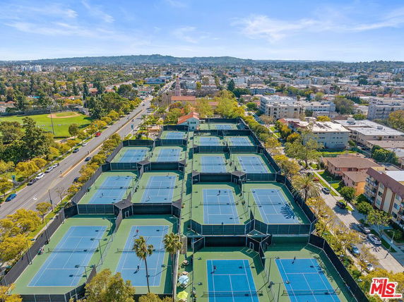 Aerial view of multiple tennis courts in a recreational complex.