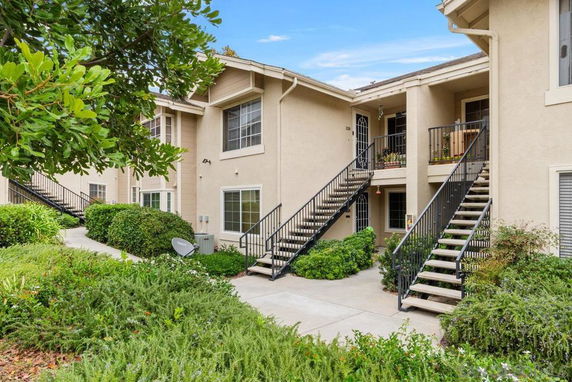 Front view of a two-story residential building with exterior staircases.