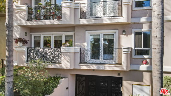 Front view of a building with decorative iron railings and multiple balconies.