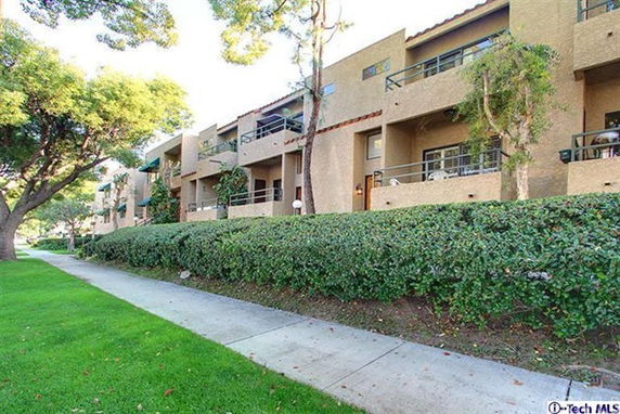 Front view of a multi-story residential building with balconies.