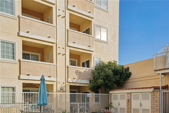 Front view of a multi-story residential building with balconies