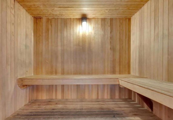 Interior view of a wooden sauna room with benches.