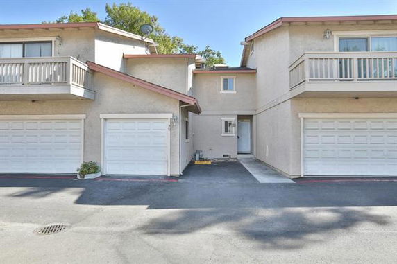 Front view of a two-story residential building with two garages and balconies.