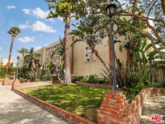 Front view of a two-story building with brick and stucco facade.