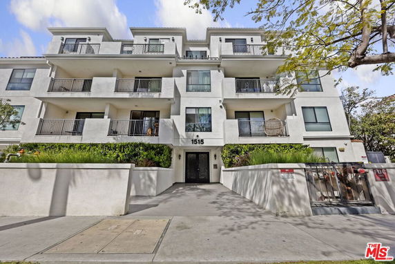 Front view of a multi-story residential building with balconies.