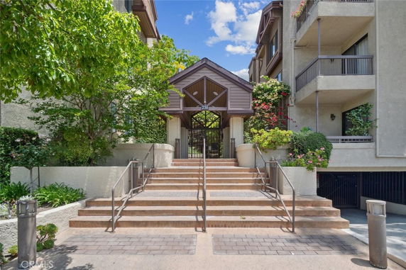 Front elevation view of a multi-story residential building with a central entrance and staircase.