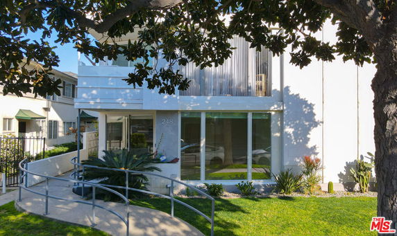Front view of a two-story building with large windows.