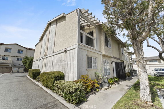 Front view of a two-story house with a balcony.