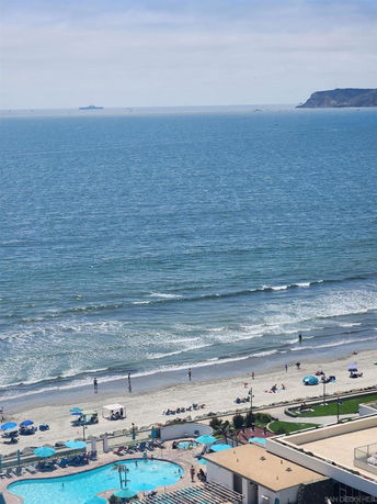 Panoramic view of a coastal area with a beach and ocean seen from a building.