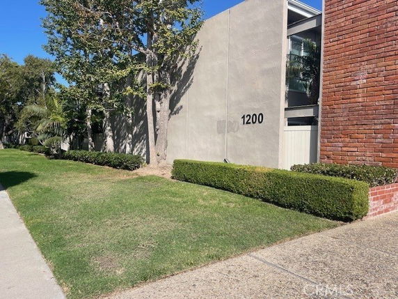 Front view of a building with a concrete exterior and visible address number.