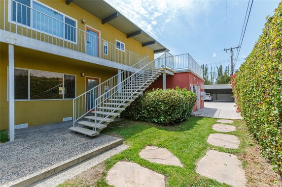 Front view of a building with an external staircase leading to the second floor.