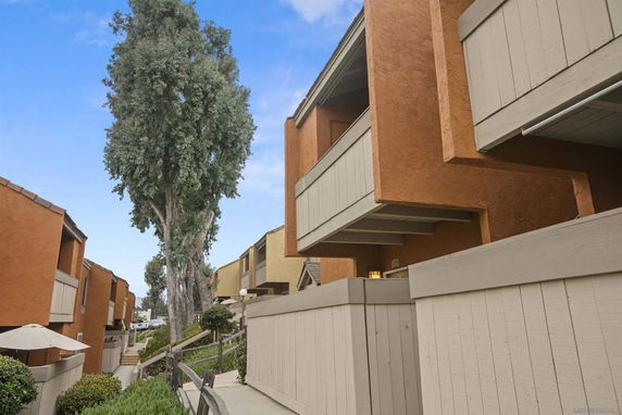 Exterior view of a residential building with multiple levels and balconies.