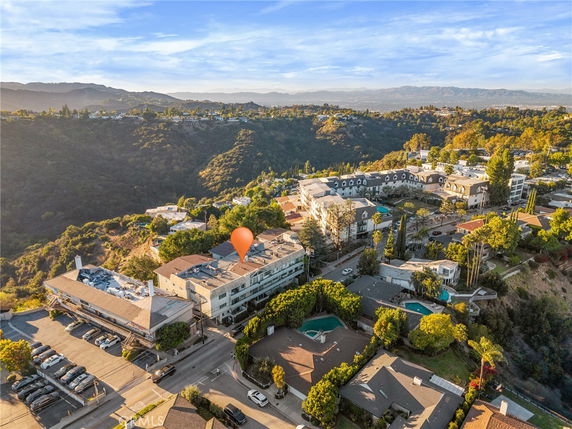 Panoramic view of a residential area with multiple buildings and surrounding greenery.