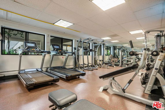 Indoor gym area with exercise equipment and treadmills