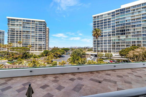 View of modern high-rise buildings with large windows and surrounding landscaped areas.