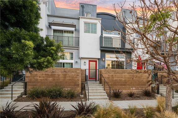 Front view of a multi-story townhouse with modern design elements.