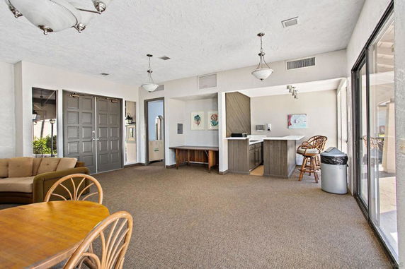 Indoor recreation area with seating and small bar counter.