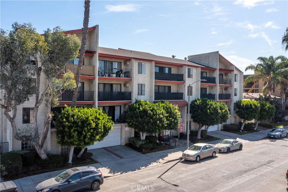 Front view of a multi-story residential apartment building with balconies.