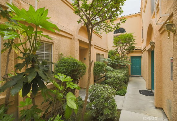 Front view of a building with an archway entrance and green door.
