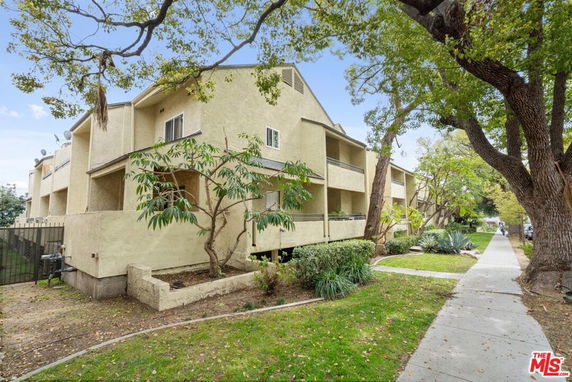 Front view of a multi-story residential building with balconies.