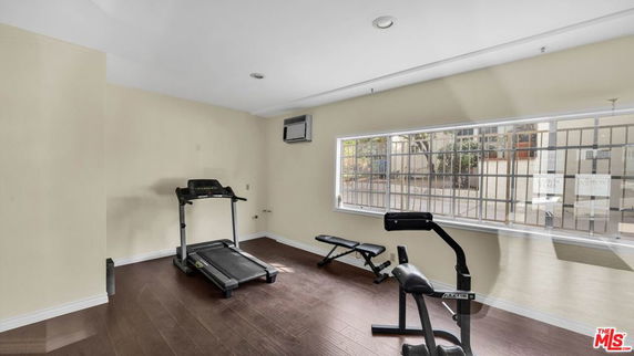 Indoor gym area with treadmill and exercise equipment.
