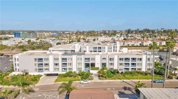 Front view of a large multi-story residential building with a flat roof.
