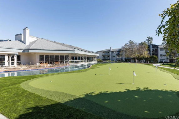View of a building with a golf putting green in the foreground.