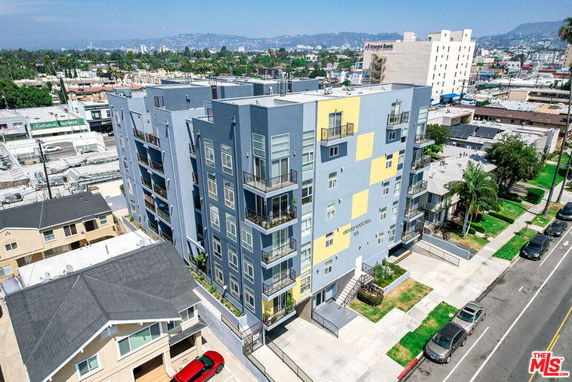 Front view of a multi-story apartment building with a modern design.