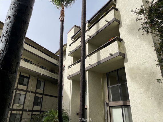 Front view of a multi-story residential building with balconies.