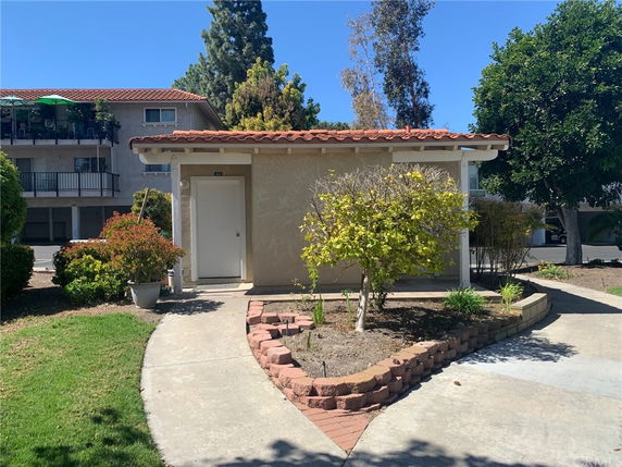 Front view of a small single-story building with a tile roof.