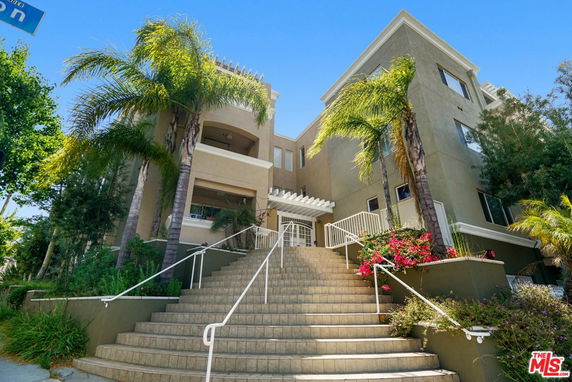 Front view of a multi-story building with staircase entrance.
