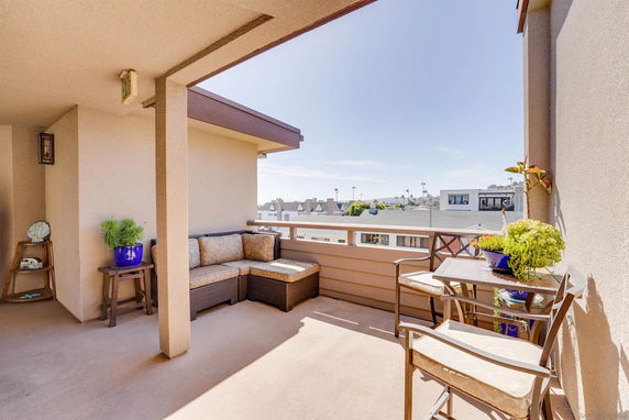 Outdoor patio area with seating and a view of the surrounding buildings.