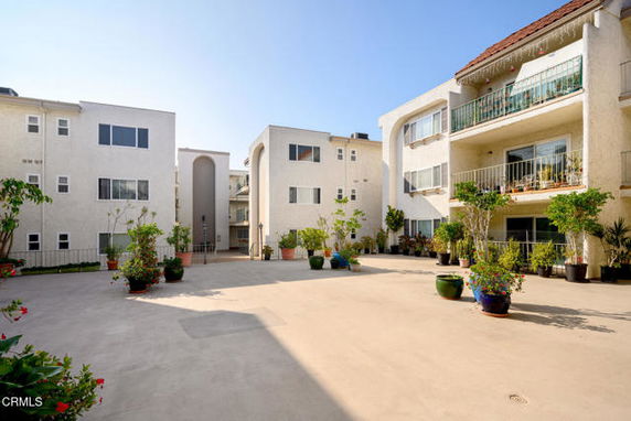 Front view of a multi-story apartment complex with balconies.