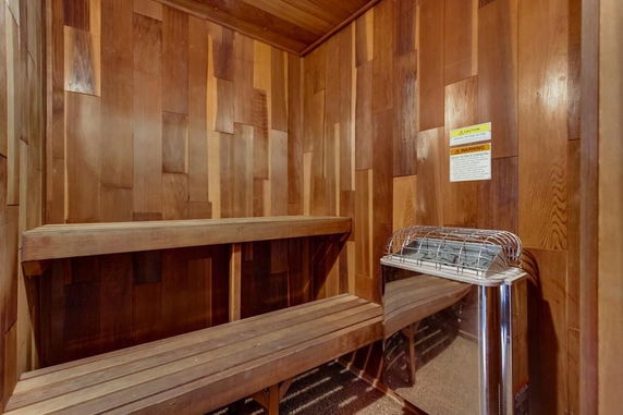 Interior view of a sauna room with wooden walls and benches.