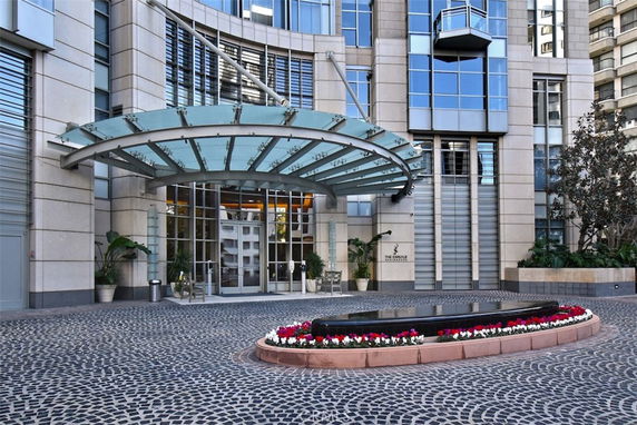 Front view of a contemporary building with a glass canopy entrance.