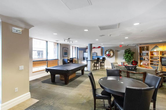 Indoor recreation area with a pool table and seating area.
