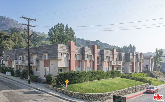 Front view of a multi-story residential building with balconies.