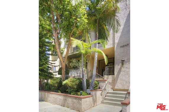 Front view of a multi-story building with a stairway entrance.