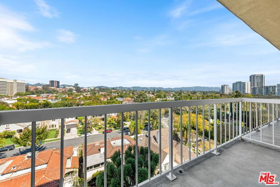 Panoramic view of cityscape from a building balcony.