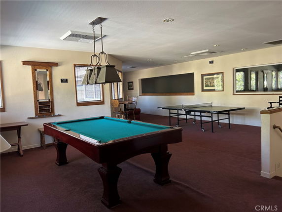 Indoor recreation area with a billiards table and a table tennis setup.
