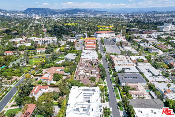 Aerial panoramic view of an urban area with various buildings and roads.