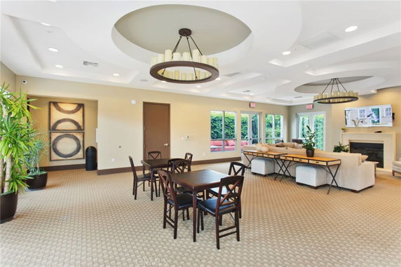 Interior of a recreation area with tables, chairs, and seating arrangement.